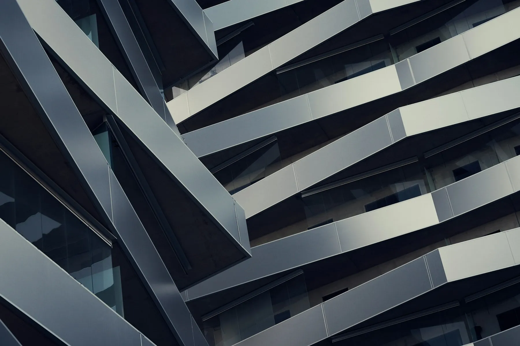 Low-angle view of a modern building rising against open sky.
