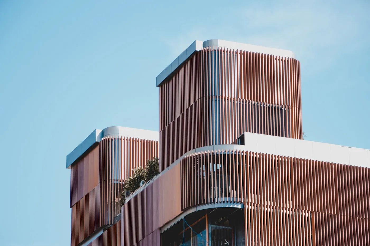 Ordered facade of a modern office building, its repeating structure seen from below.