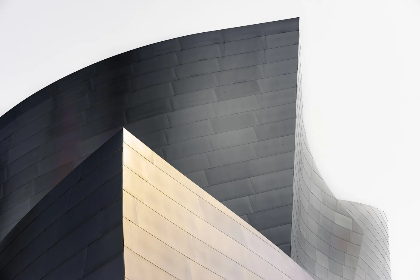 Detail of a plain concrete wall, its surface catching flat daylight.