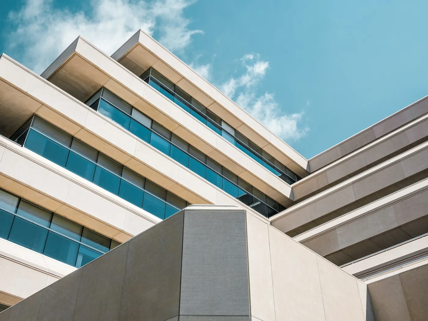 Low-angle view of a concrete building edge under an open sky.